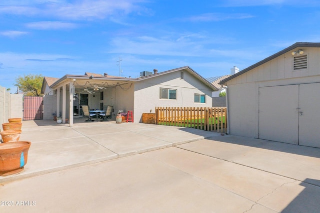 back of property featuring stucco siding, a patio, and fence