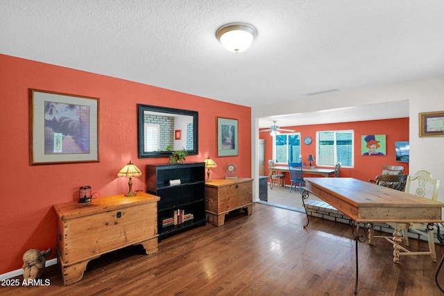 dining area with visible vents, a textured ceiling, and wood finished floors