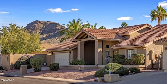 view of front of home featuring a mountain view and a garage