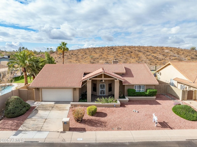 1017 E Grandview Rd, Phoenix, AZ 85022 - view of front of house with a tile roof, stucco siding, an attached garage, and fence