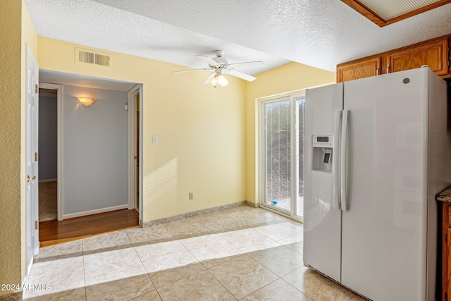 1017 E Grandview Rd, Phoenix, AZ 85022 - kitchen with white refrigerator with ice dispenser, ceiling fan, brown cabinetry, a textured ceiling, and light tile patterned floors