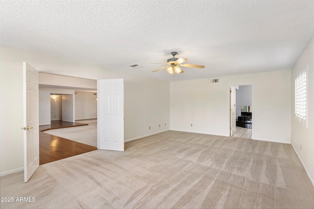 1017 E Grandview Rd, Phoenix, AZ 85022 - spare room with light colored carpet, ceiling fan, baseboards, and a textured ceiling