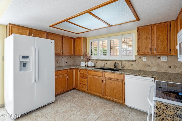 1017 E Grandview Rd, Phoenix, AZ 85022 - kitchen with white appliances, a sink, brown cabinets, backsplash, and a textured ceiling