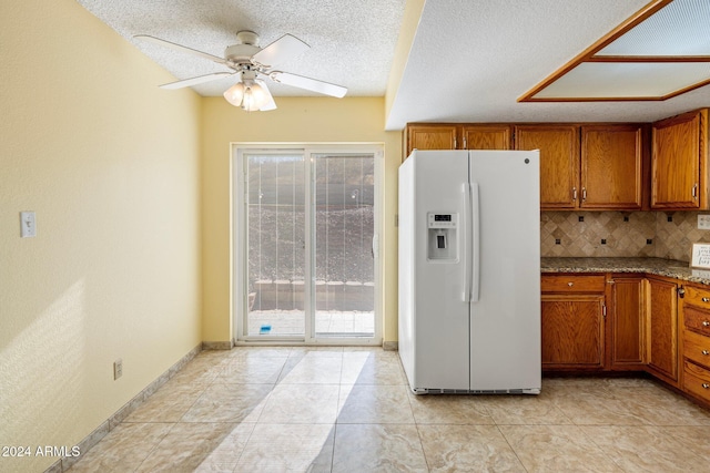 1017 E Grandview Rd, Phoenix, AZ 85022 - kitchen with white refrigerator with ice dispenser, brown cabinets, ceiling fan, healthy amount of natural light, and a textured ceiling