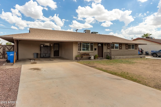 ranch-style house featuring a carport