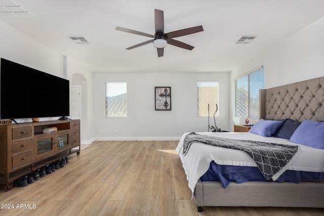 bedroom featuring light hardwood / wood-style flooring, multiple windows, and ceiling fan