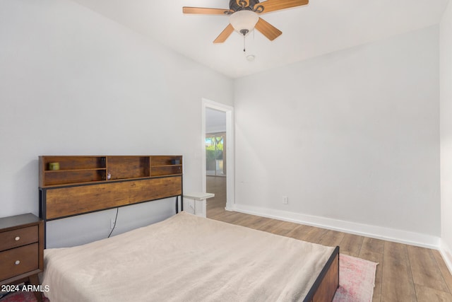 bedroom with ceiling fan and light hardwood / wood-style flooring