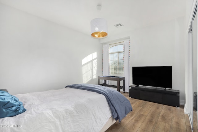 bedroom featuring a closet and light wood-type flooring