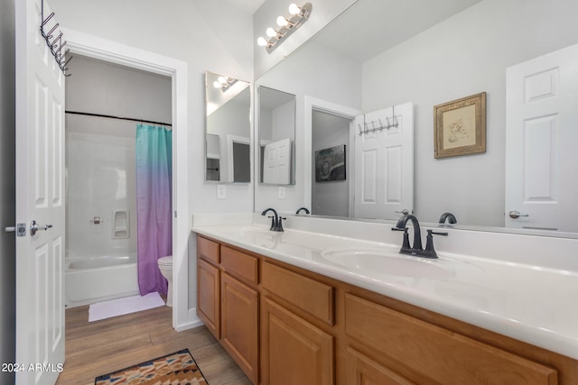 full bathroom featuring toilet, hardwood / wood-style floors, shower / tub combo with curtain, and vanity