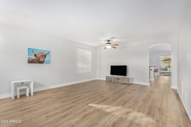 unfurnished living room with light wood-type flooring and ceiling fan