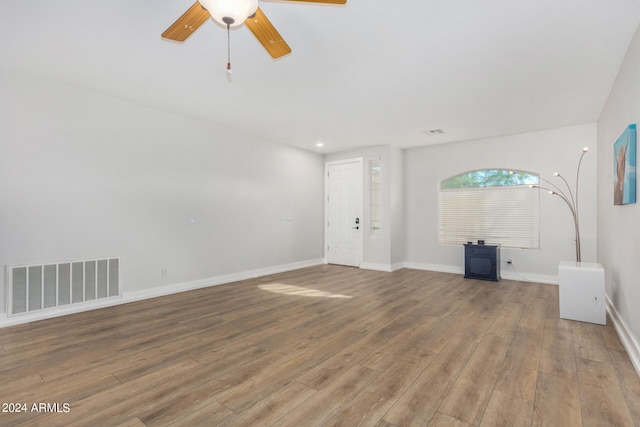 unfurnished living room featuring hardwood / wood-style floors and ceiling fan