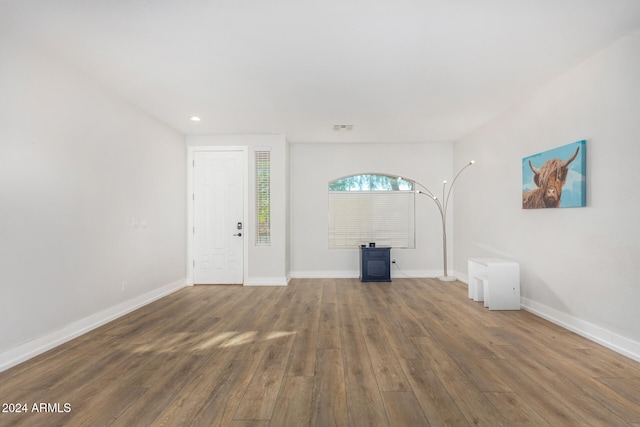 unfurnished living room featuring dark hardwood / wood-style flooring