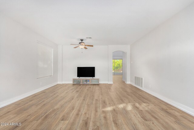 unfurnished living room featuring light hardwood / wood-style flooring and ceiling fan