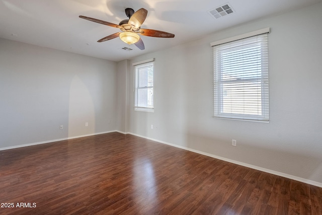 spare room featuring ceiling fan and dark hardwood / wood-style flooring