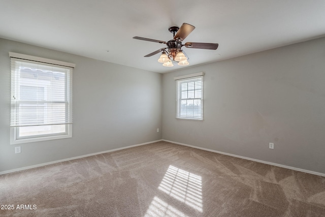 carpeted empty room featuring ceiling fan