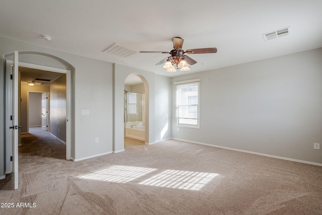 empty room featuring ceiling fan and light colored carpet