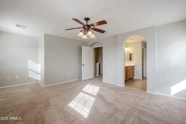 carpeted spare room with ceiling fan