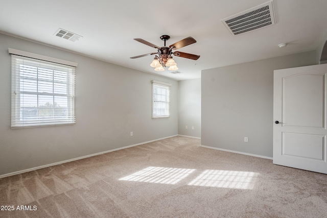 unfurnished room with ceiling fan and light colored carpet