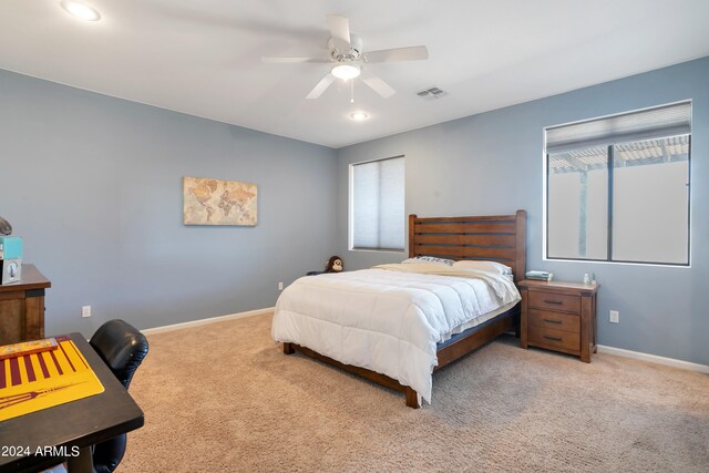 bedroom with light carpet and ceiling fan