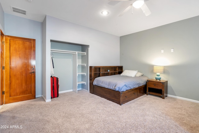 carpeted bedroom featuring ceiling fan and a closet