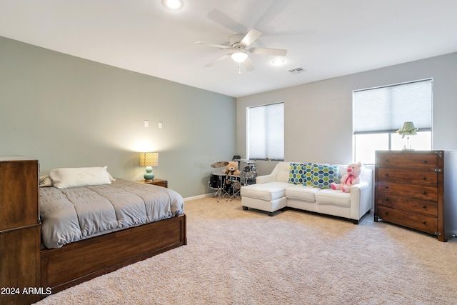 bedroom featuring ceiling fan and light carpet