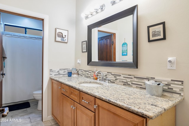 bathroom featuring toilet, tile patterned flooring, a shower with curtain, vanity, and backsplash