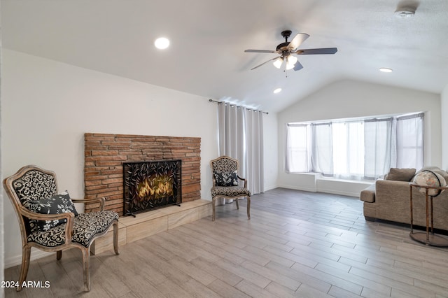 living area featuring ceiling fan, lofted ceiling, and light hardwood / wood-style floors