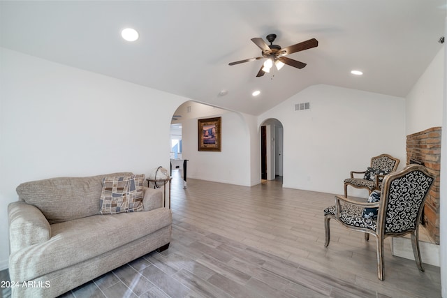 living area with light wood-type flooring, lofted ceiling, and ceiling fan