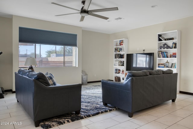 tiled living room with built in features and ceiling fan