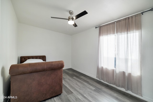 living area with light hardwood / wood-style floors and ceiling fan