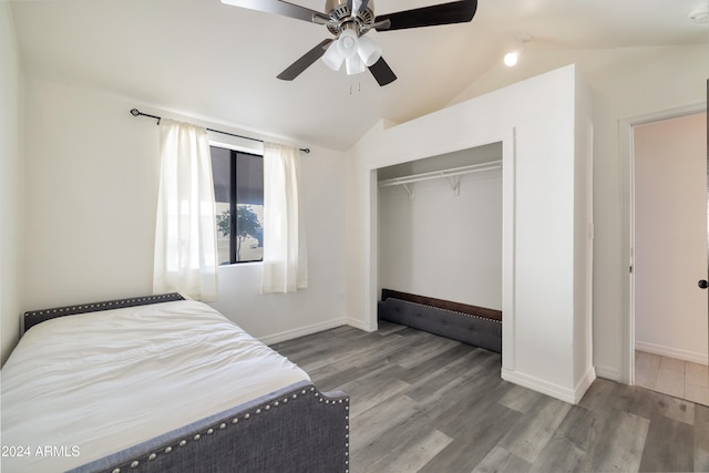 bedroom featuring hardwood / wood-style flooring, ceiling fan, vaulted ceiling, and a closet