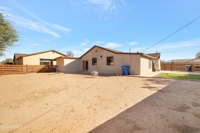 back of property with a patio