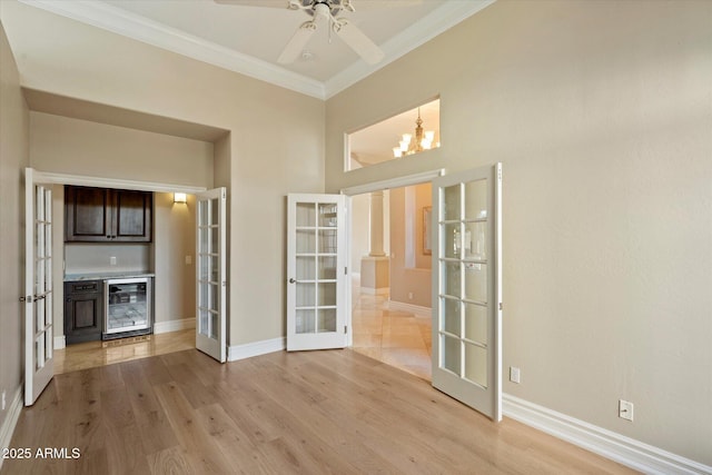 1507 E Treasure Cove Dr, Gilbert, AZ 85234 - interior space with ornamental molding, wine cooler, baseboards, french doors, and light wood finished floors