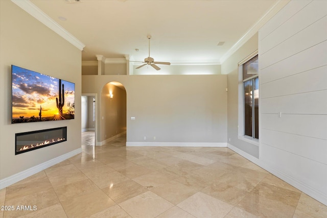 1507 E Treasure Cove Dr, Gilbert, AZ 85234 - interior space featuring a ceiling fan, arched walkways, baseboards, a glass covered fireplace, and ornamental molding