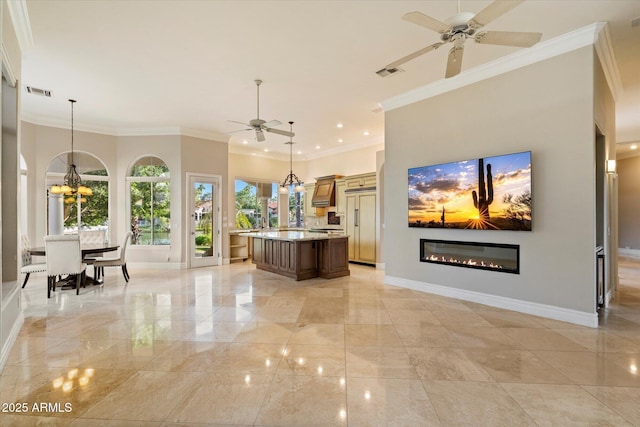 1507 E Treasure Cove Dr, Gilbert, AZ 85234 - kitchen with visible vents, baseboards, a glass covered fireplace, and ceiling fan with notable chandelier