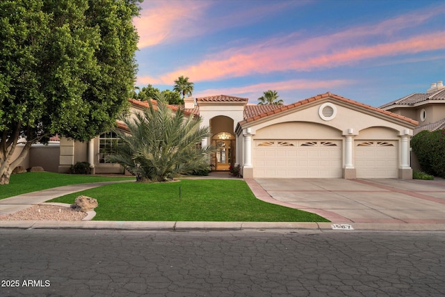 1507 E Treasure Cove Dr, Gilbert, AZ 85234 - mediterranean / spanish home featuring an attached garage, a front lawn, stucco siding, a tiled roof, and driveway