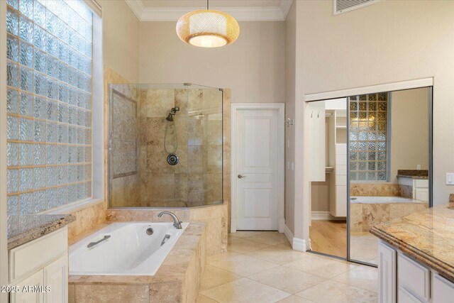 1507 E Treasure Cove Dr, Gilbert, AZ 85234 - bathroom featuring crown molding, a tile shower, tile patterned flooring, baseboards, and a bath