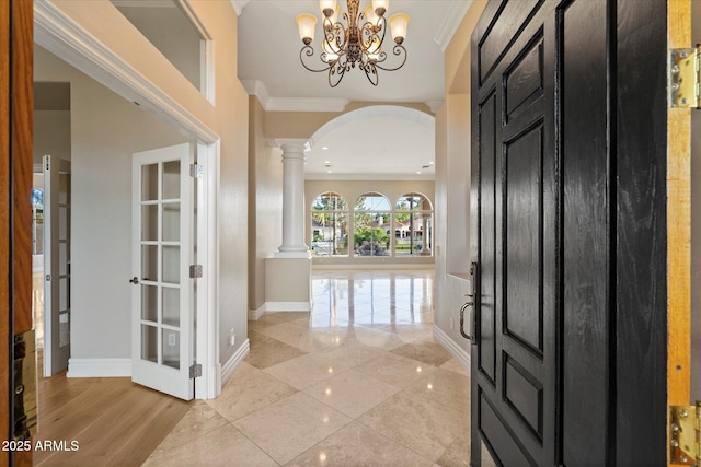 1507 E Treasure Cove Dr, Gilbert, AZ 85234 - entryway featuring decorative columns, arched walkways, baseboards, a chandelier, and ornamental molding