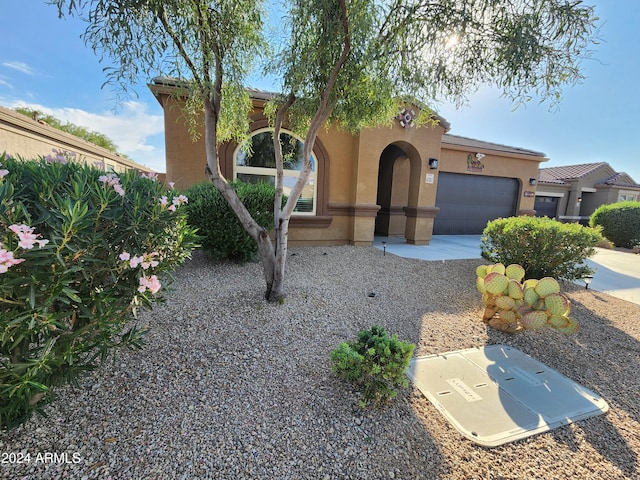 mediterranean / spanish-style house with a garage