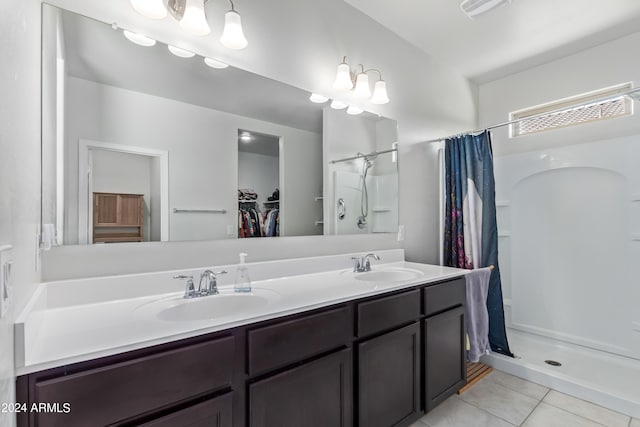 bathroom with tile patterned flooring, curtained shower, and vanity