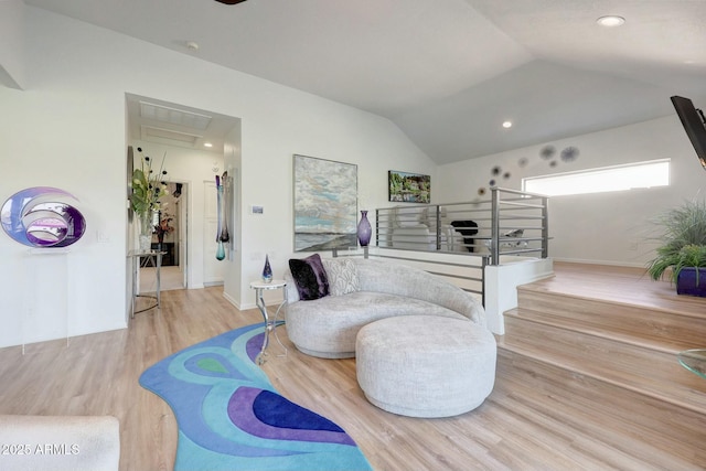 interior space with lofted ceiling and light hardwood / wood-style flooring