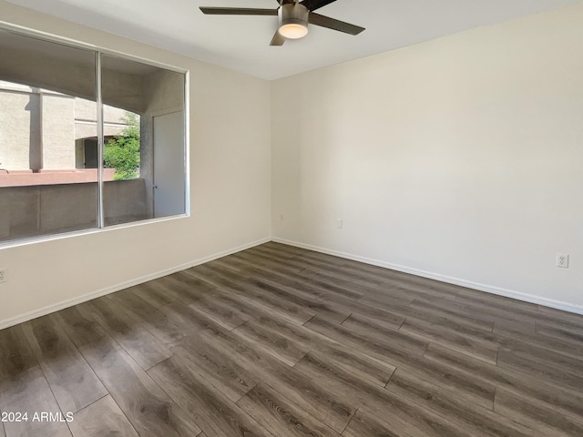 empty room featuring dark hardwood / wood-style flooring and ceiling fan