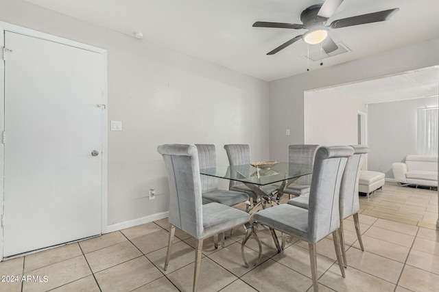 tiled dining space featuring ceiling fan