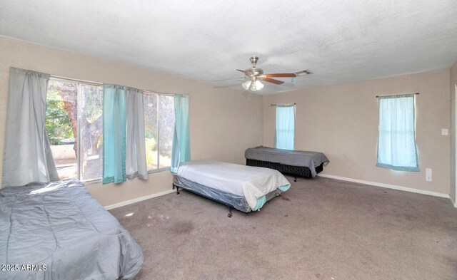 4813 W Belmont Ave, Glendale, AZ 85301 - bedroom featuring ceiling fan, a textured ceiling, carpet, baseboards, and visible vents