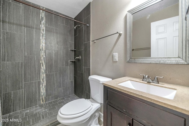 4813 W Belmont Ave, Glendale, AZ 85301 - full bathroom with toilet, a textured wall, tiled shower, and vanity