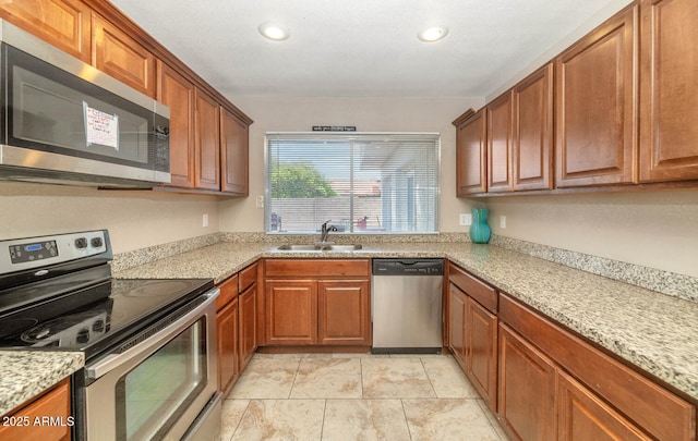 4813 W Belmont Ave, Glendale, AZ 85301 - kitchen featuring brown cabinetry, a sink, appliances with stainless steel finishes, and recessed lighting