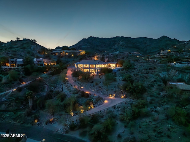 aerial view at dusk featuring a mountain view