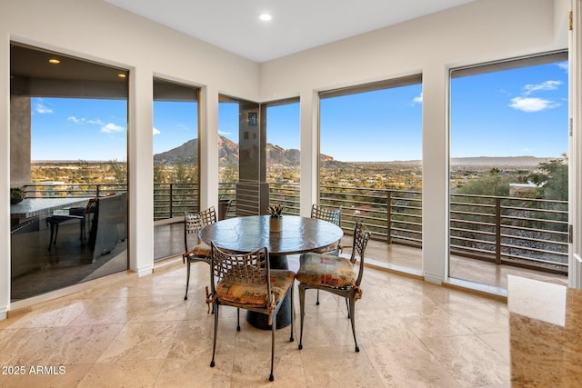 sunroom / solarium featuring a mountain view