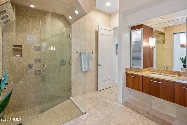 bathroom with vanity and a shower with shower door