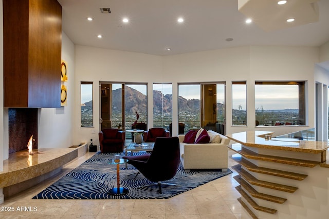 living room with a high ceiling and a mountain view